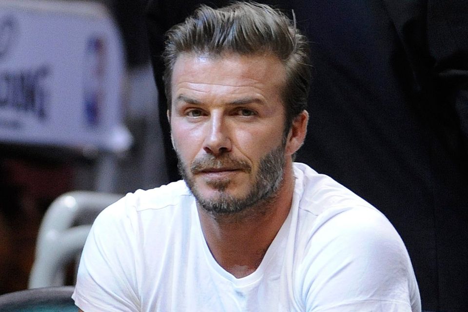 FILE - epa04194381 Former English soccer player David Beckham watches the Brooklyn Nets and the Miami Heat during their Eastern Conference Semifinals NBA playoff game at the American Airlines Arena in Miami, Florida, USA, 06 May 2014. EPA/RHONA WISE