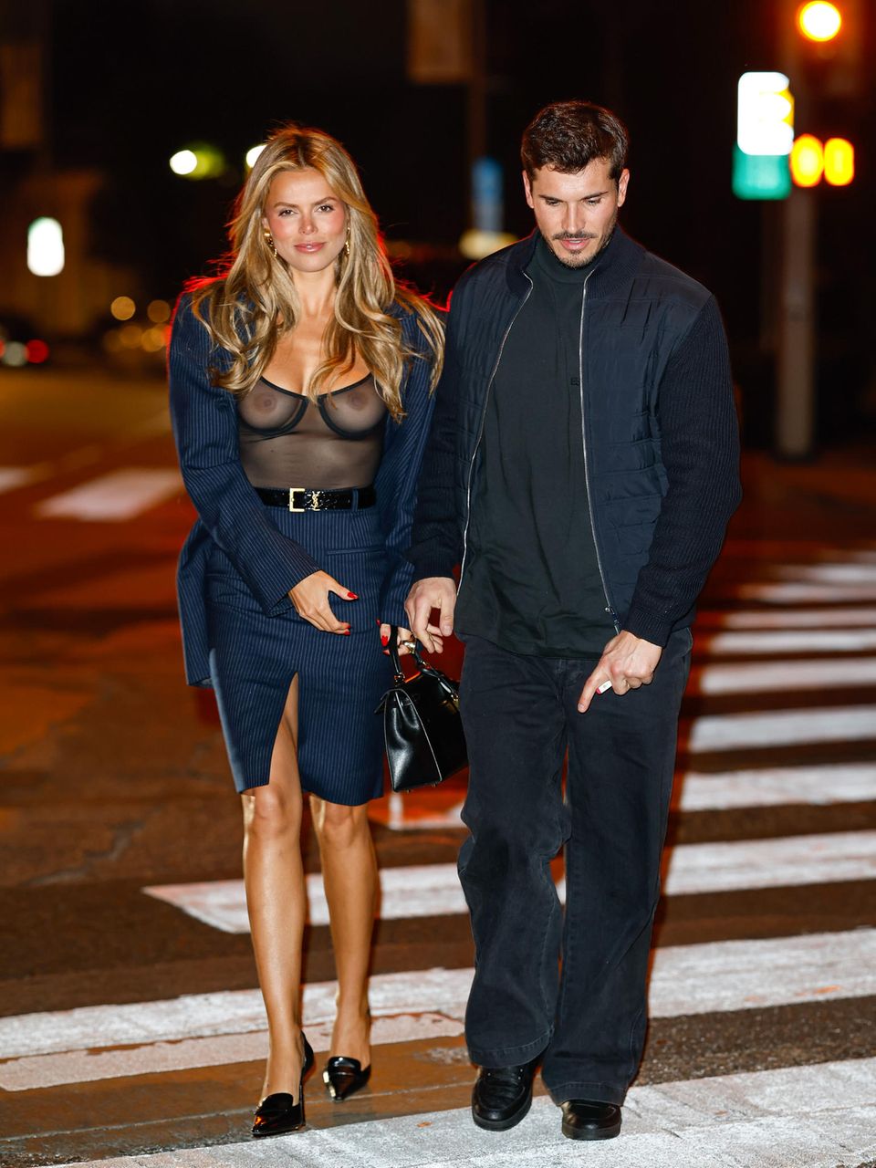 Auf den ersten Blick wirkt der Look aus Bleistiftrock, Blazer und spitzen Pumps von Model Brooks Nader fast business-like – auf den zweiten Blick wird erst klar: durch das transparente Top sieht man alles. Egal! Ihr und Date Gleb Savchenko scheint's zu gefallen.
